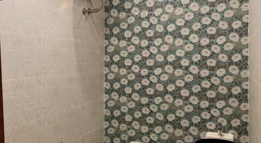 Deluxe Villa bathroom with a glass shower screen and floral tiling